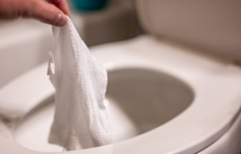 disposable wipes being flushed down a toilet where they can cause clogging and problems